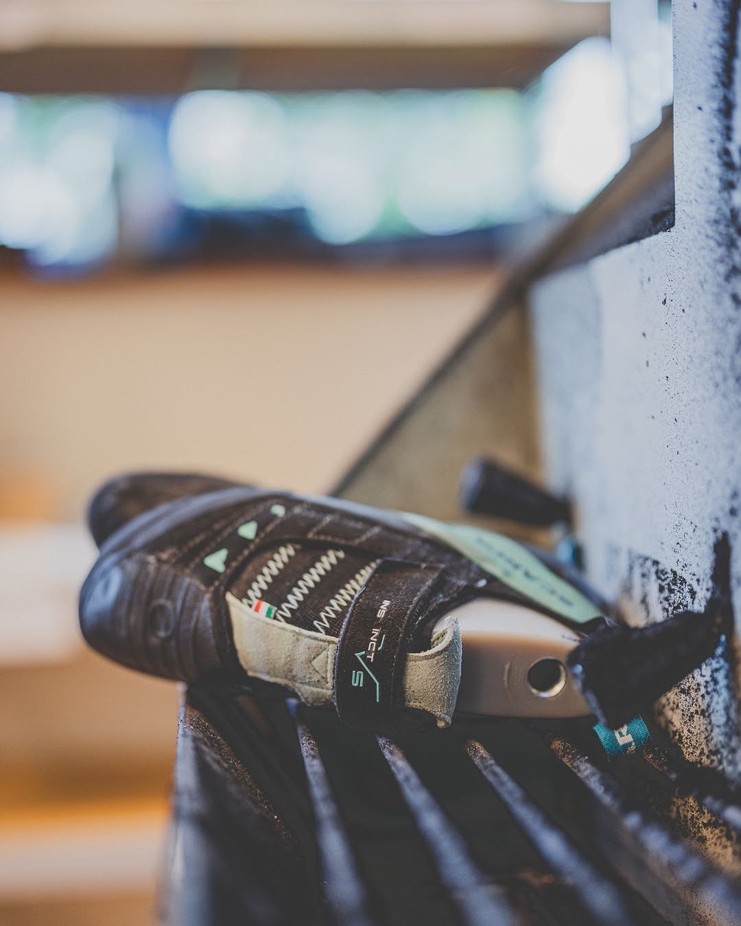 Worn climbing shoe in for repair on the workshop bench