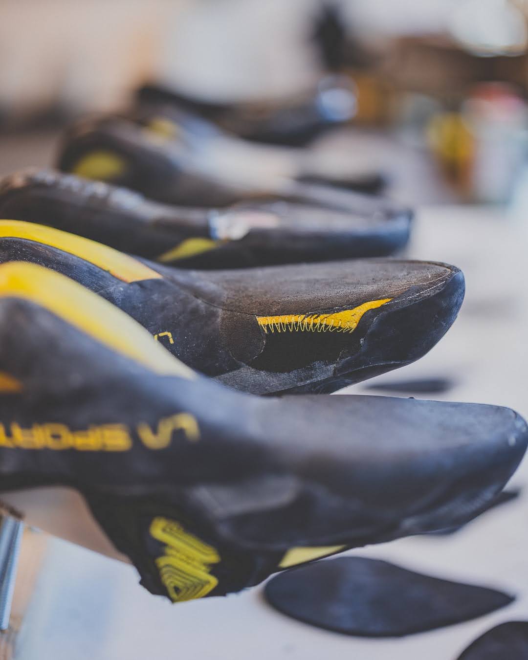 Row of freshly resoled climbing shoes