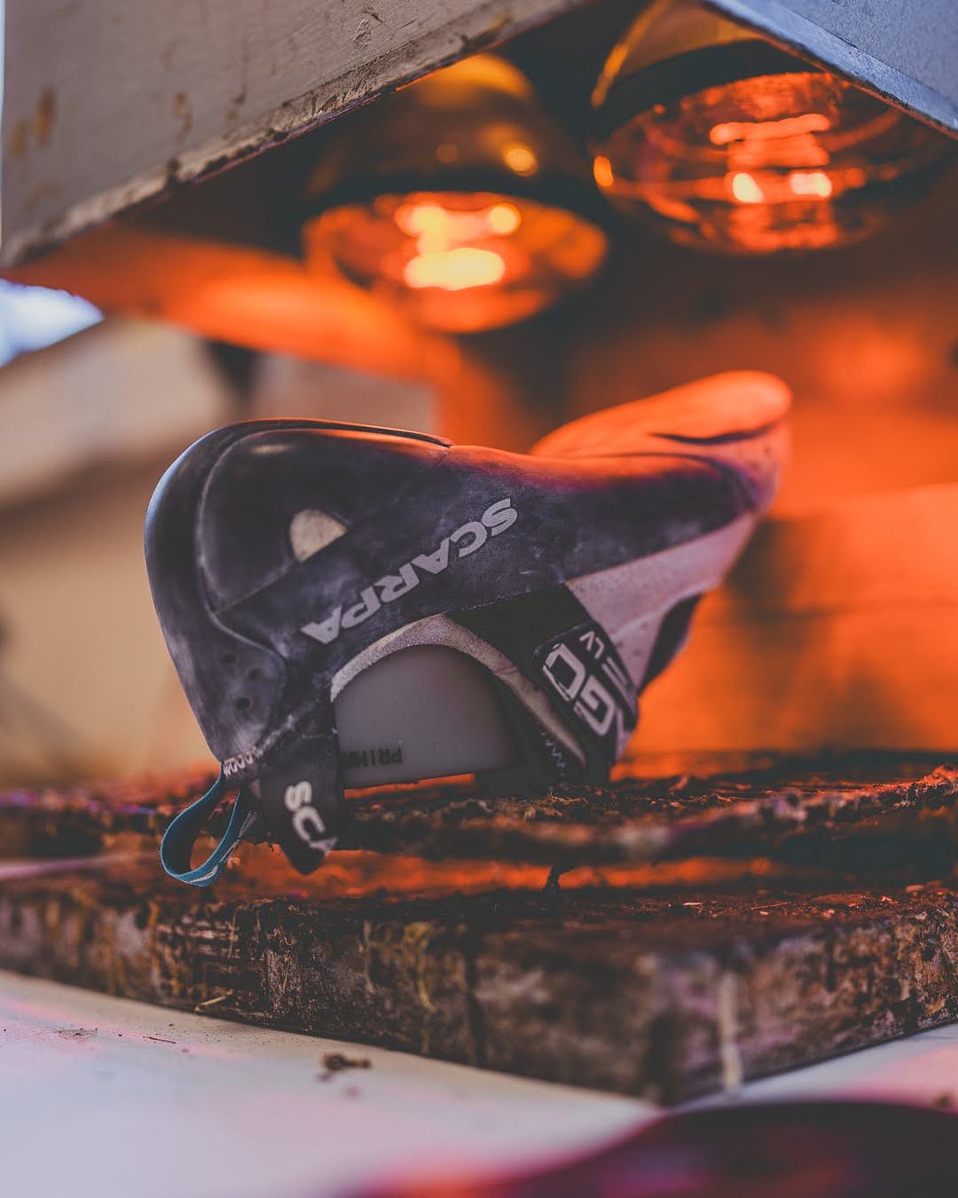 Resoled climbing shoe curing under heat lamps